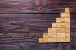 A wooden blocks cube over black wooden textured background with copy space for add word text title. Concept or conceptual Wood block stair or seven steps. Cubic photo