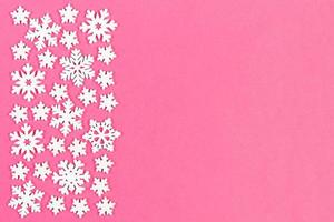 Set of white snowflakes on colorful background. Top view of Christmas ornament. New Year time concept with empty space for your design photo