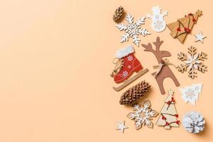 Top view of New Year toys and decorations on orange background. Christmas time concept with empty space for your design photo