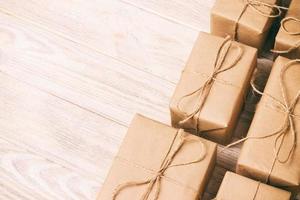 Gift wrapping composition. homemade wrapped present boxes on wooden background. above view copy space. Toned photo