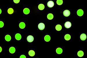 Unfocused abstract colourful bokeh black background. defocused and blurred many round green light photo