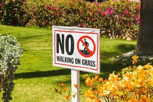 No walking on grass warning sign in the garden photo
