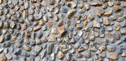 piedra de grava o pared de patrón de roca dura para el fondo. diseño de estructura exterior en estilo loft y arte natural del concepto de papel tapiz foto