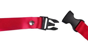 Side release buckle from plastic with Red belt nylon on the white background. photo