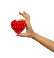Hand holding a red heart isolated on white background photo
