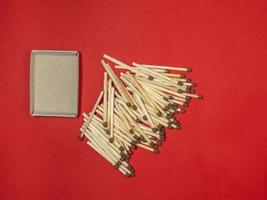 Matchsticks on a red background. Safe handling of fire. Fire dangers. Lots of matches.  household still life