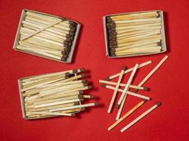 Matches on a red background. Safe handling of fire. Fire dangers. Lots of matches. photo