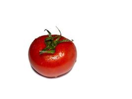 Greenhouse tomato on a white background. Ripe vegetable. Tomato isolate. Vegetables in water drops photo