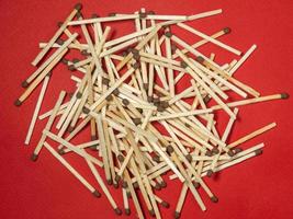 Matchsticks on a red background. Safe handling of fire. Fire dangers. Lots of matches.  household still life photo