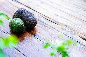 Fresh green avocado on a wooden table is a very useful and vitamin fruit. photo