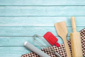 Top view set of kitchen utensils and ingredients for bakery on blue wooden floor. photo