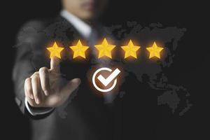 Businessman give rating to service experience, User Experience concept, Customer review satisfaction feedback survey, Customer giving a Five Star to business ranking photo