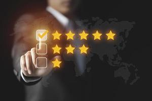 Businessman give rating to service experience, User Experience concept, Customer review satisfaction feedback survey, Customer giving a Five Star to business ranking photo