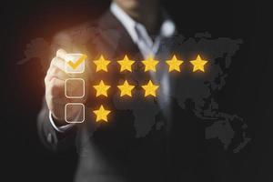 Businessman give rating to service experience, User Experience concept, Customer review satisfaction feedback survey, Customer giving a Five Star to business ranking photo