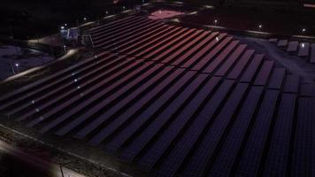 Aerial view of a solar farm producing clean energy during the evening with twilight and visible all around area photo