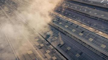 Toxic fumes spread from the roof of an industrial plant. Industrial plants emit large amounts of smoke from the factories during production. which creates air pollution for the world. photo