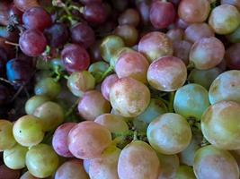 Healthy fruits Red grapes background dark grapes, Red grapes in the supermarket a group of local markets ready to eat grapes suitable for juices and fresh drinks photo