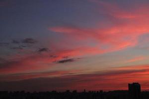 Colorful cloudy twilight beautiful sky cityscape sunset and morning sunrise. Dramatic evening night early morning view with city buildings silhouette. Panoramic background concept. Copy space for text photo