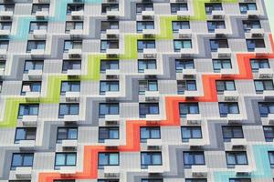 Windows of residential apartment building. Facade of a modern house. New architecture design. World habitat day. Urban infrastructure development concept photo