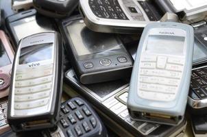 KHARKOV, UKRAINE - MAY 12, 2022 Bunch of old used outdated mobile phones. Recycling electronics in the market cheap photo