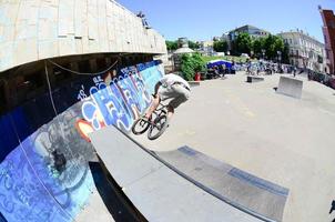 KHARKIV, UKRAINE - 27 MAY, 2022 Freestyle BMX riders in a skatepark during the annual festival of street cultures photo