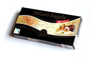 KHARKOV. UKRAINE - MAY 2, 2022 Henry Lambertz Mozart-Kugeln luxury dark chocolate candies in black box on white table photo