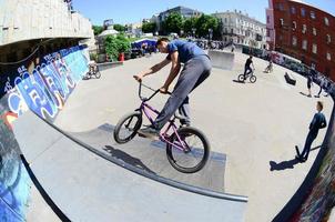 KHARKOV. UKRAINE - MAY 2, 2022 Freestyle BMX riders in a skatepark during the annual festival of street cultures photo