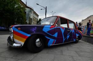 KHARKOV. UKRAINE - MAY 2, 2022 Festival of street art. A car that was painted by masters of street art during the festival. The result of the work of several graffiti artists. Original aerography photo