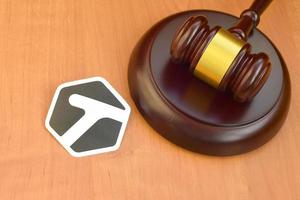 KHARKOV, UKRAINE - MAY 12, 2022 Tagged paper logo lies with wooden judge gavel. Entertainment lawsuit concept photo