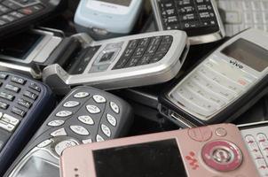 KHARKOV, UKRAINE - MAY 12, 2022 Bunch of old used outdated mobile phones. Recycling electronics in the market cheap photo
