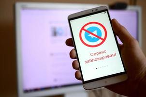 KHARKOV. UKRAINE - MAY 17, 2022 A mobile phone with the Telegram app screen with a prohibiting sign and russian inscription Access is denied. Roskomnadzor blocked the Telegram service in Russia photo