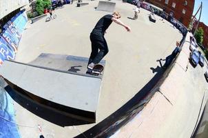 KHARKOV. UKRAINE - MAY 2, 2022 Skateboarding contest in outdoors skate park during the annual festival of street cultures photo