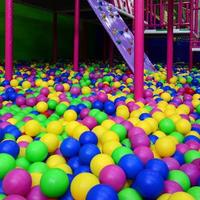 Many colorful plastic balls in a kids' ballpit at a playground photo