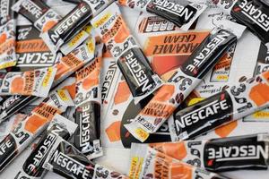 KHARKOV. UKRAINE - MAY 17, 2022 Many Nescafe caramel cream coffee sticks. Nescafe is a brand of coffee made by Nestle, swiss multinational conglomerate corporation photo