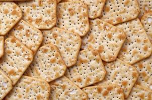 KHARKOV. UKRAINE - MAY 2, 2022 Tuc Original Snack Crackers lies on market table stacked in big pile photo