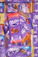 KHARKOV, UKRAINE - MAY 5, 2022 Many wrappings of purple Milka chocolate. Milka is a Swiss brand of chocolate confection manufactured by company Mondelez International photo