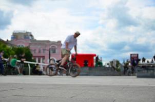 Defocused image of a lot of people with bmx bikes. Meeting of fans of extreme sports photo