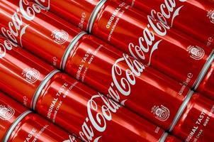KHARKOV. UKRAINE - MAY 2, 2022 Coca-Cola logo printed on aluminium tin cans close up in shopping mall photo