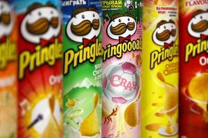 KHARKOV, UKRAINE - MAY 5, 2022 Pringles variety of flavors. Many cardboard tube cans with Pringles potato chips. Pringles is a brand of potato snack chips owned by the Kellogg Company photo