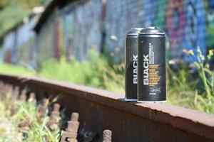 KHARKOV. UKRAINE - MAY 17, 2022 Used Montana black aerosol spray cans against graffiti paintings. MTN or Montana-cans is manufacturer of high pressure spray paint goods photo