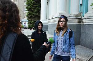 KHARKOV. UKRAINE - MAY 17, 2022 Participants of the first LGBT action in Kharkov give interviews about an unexpected attack and disruption of the event photo