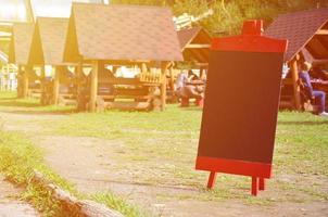 A large board as a menu for an open-air restaurant in a mountainous area. Free space for your text photo