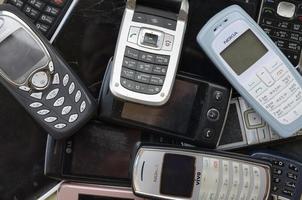 KHARKOV, UKRAINE - MAY 12, 2022 Some old used outdated mobile phones. Recycling electronics in the market cheap photo