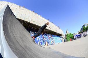 KHARKOV. UKRAINE - MAY 2, 2022 Skateboarding contest in outdoors skate park during the annual festival of street cultures photo