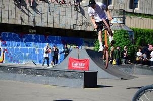 KHARKOV. UKRAINE - MAY 2, 2022 Freestyle BMX riders in a skatepark during the annual festival of street cultures photo