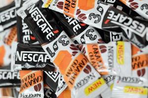 KHARKOV. UKRAINE - MAY 17, 2022 Many Nescafe caramel cream coffee sticks. Nescafe is a brand of coffee made by Nestle, swiss multinational conglomerate corporation photo