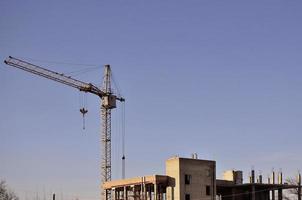 Building under construction with crane photo