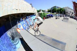 KHARKOV. UKRAINE - MAY 2, 2022 Freestyle BMX riders in a skatepark during the annual festival of street cultures photo