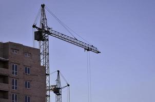 Building under construction with crane photo