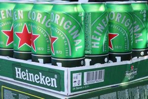 KHARKOV. UKRAINE - MAY 2, 2022 Green tin cans of Heineken lager beer produced by the Dutch brewing company Heineken N.V. photo